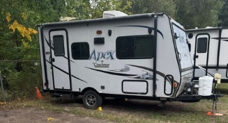 Small camper in outdoor storage